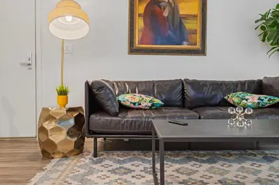 a living room with a leather couch and a table at 11 Best Walk location of SM in Los Angeles