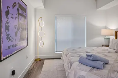 a bedroom with a bed with a blue towel on it at 11 Best Walk location of SM in Los Angeles