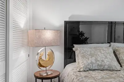 a bedroom with a bed and a lamp on a table at 11 Best Walk location of SM in Los Angeles