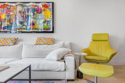 a living room with a couch and a yellow chair at 9 Advantages Center Santa Manica in Los Angeles