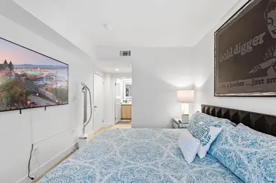 a bedroom with a bed and a large painting on the wall at 9 Advantages Center Santa Manica in Los Angeles