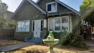 a house with a statue in front of a house at Eight Street Apartments in Long Beach