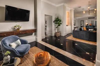a living room with a blue chair and a couch at Stylish 2 Bed 2.5 Bath Condo Near Beverly Hills. in Los Angeles