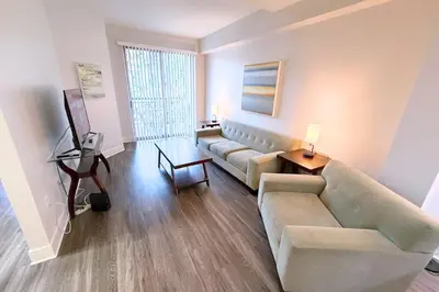 a living room with a couch and a table at Stylish 2 Bed 2.5 Bath Condo Near Beverly Hills. in Los Angeles