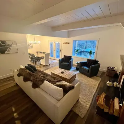 a living room with a couch and chairs and a table at Lake Arrowhead Lux Black Cabin in Lake Arrowhead