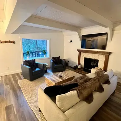 a living room with a couch and a fireplace at Lake Arrowhead Lux Black Cabin in Lake Arrowhead