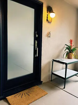 a door with a table and a plant next to it at Luxury 2br 2ba Beverly Hills Near Cedars Sinai in Los Angeles