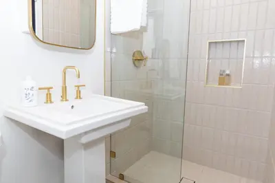 a white bathroom with a sink and a shower at Luxury 2br 2ba Beverly Hills Near Cedars Sinai in Los Angeles