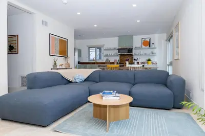 a blue couch in a living room with a table at Luxury 2br 2ba Beverly Hills Near Cedars Sinai in Los Angeles