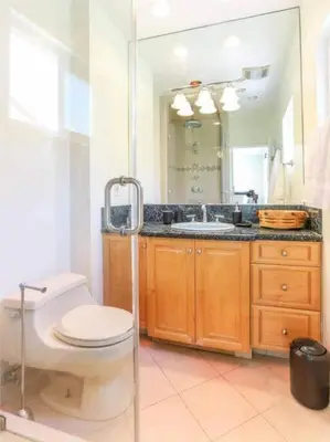 a bathroom with a toilet and a sink and a mirror at Large 5 BR- Beverly Hills Adj in Los Angeles