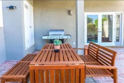 a picnic table with a grill and a potted plant on it at Large 5 BR- Beverly Hills Adj in Los Angeles