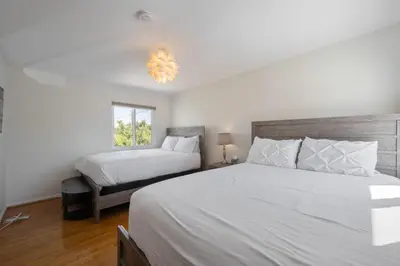a bedroom with two beds and a window at Large 5 BR- Beverly Hills Adj in Los Angeles