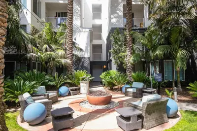a courtyard with wicker chairs and palm trees at Playa Vista 1BR w Pool Gym Spa nr the beach LAX-138 in Los Angeles
