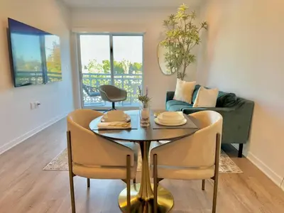 a living room with a table and chairs and a couch at NEW One Bedroom Penthouse, Silver Lake + Parking! in Los Angeles