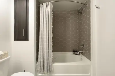 a bathroom with a bath tub with a shower curtain at Luxury 1BDR centrally located in Hollywood in Los Angeles