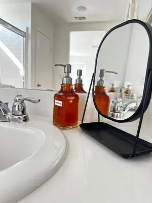 a mirror sitting on a bathroom counter next to a sink at Claremont Colleges And Ontairo Mills Single Villa stay more 30 nights in Upland