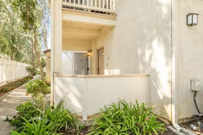a white house with a fence and plants at Thousand Oaks 2br near shopping dining bars LAX-1157 in Oak Park