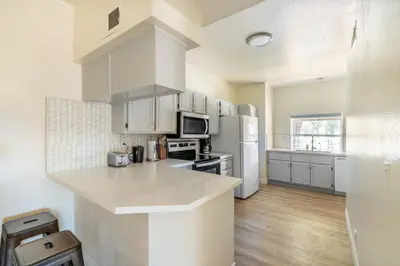 a kitchen with white cabinets and a counter top at Thousand Oaks 2br near shopping dining bars LAX-1157 in Oak Park
