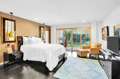 a bedroom with a large bed and a living room at Edwin by AvantStay Hollywood Hills Luxury Pool in Los Angeles