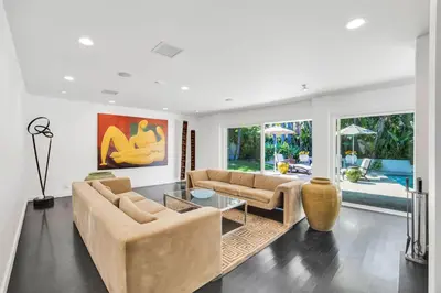 a living room with two couches and a table at Edwin by AvantStay Hollywood Hills Luxury Pool in Los Angeles