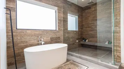 a bathroom with a tub and a glass shower at Luxe WeHo Villa Walk to Melrose Ave Pool Hot Tub North Vista by AvantStay in Los Angeles