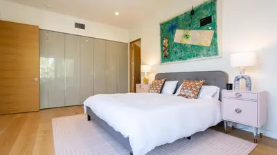 a bedroom with a large white bed and a cabinet at Luxe WeHo Villa Walk to Melrose Ave Pool Hot Tub North Vista by AvantStay in Los Angeles