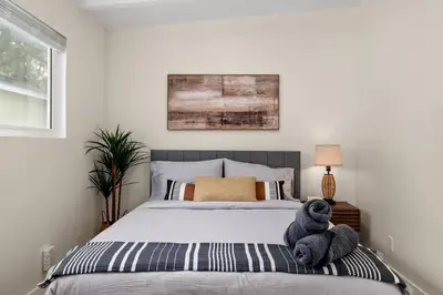 a teddy bear sitting on a bed in a bedroom at Charming Zen Venice Beach 3BR Home w/Patio & W/D in Los Angeles