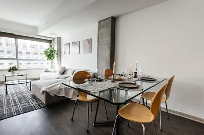 a dining room with a table and chairs and a couch at Luxurious Hollywood condo in Los Angeles