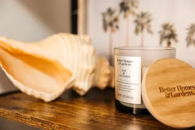 a candle and a wooden spoon on a wooden table at Luxurious Hollywood condo in Los Angeles