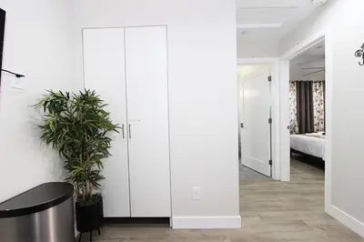 a room with white cabinets and a table and a bed at NEW! 2-Bedroom Fontana Guest House close to Kaiser Permanente in Fontana