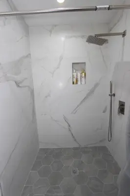 a bathroom with white marble walls and a shower at NEW! 2-Bedroom Fontana Guest House close to Kaiser Permanente in Fontana
