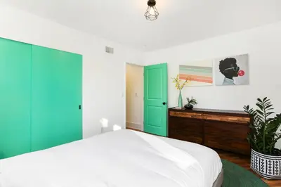 a bedroom with green and white doors and a bed at Peace Palace 4803 in Los Angeles