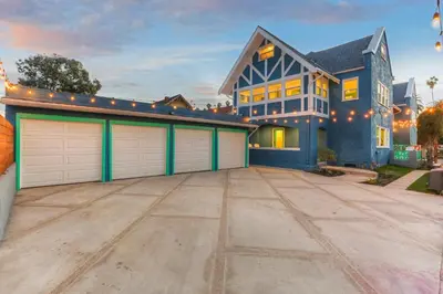 a large blue house with two garage doors at Peace Palace 4803 in Los Angeles