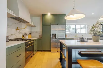 a kitchen with green cabinets and a large island at New Home Universal sleeps 18 hot tub in Los Angeles