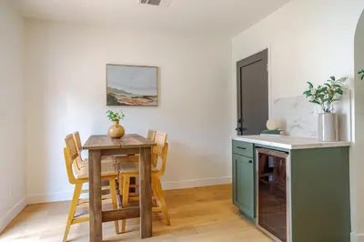 a kitchen and dining room with a table and chairs at New Home Universal sleeps 18 hot tub in Los Angeles