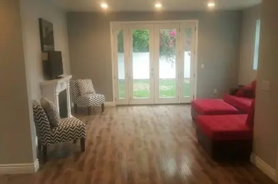 a living room with a red couch and chairs at Lake Balboa 7 Bedroom 5 Bathroom Compound in Los Angeles
