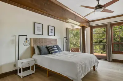 a bedroom with a bed and a ceiling fan at Lake Reflection Point Upscale Lake House 4 Bed and 4.5 Bath in Lake Arrowhead