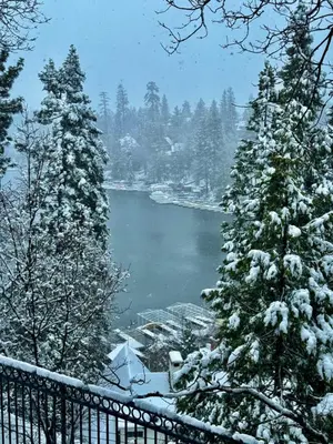 a view of a lake with snow covered trees at Lake Reflection Point Upscale Lake House 4 Bed and 4.5 Bath in Lake Arrowhead