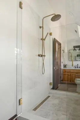 a bathroom with a shower with a glass door at Lake Reflection Point Upscale Lake House 4 Bed and 4.5 Bath in Lake Arrowhead