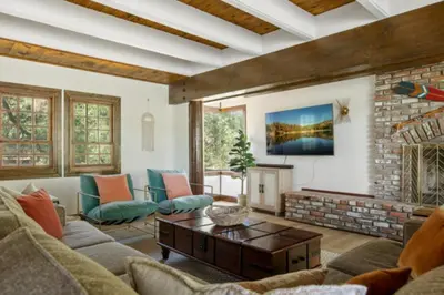 a living room with a couch and a fireplace at Lake Reflection Point Upscale Lake House 4 Bed and 4.5 Bath in Lake Arrowhead