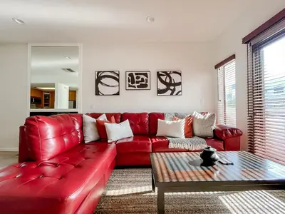 a red leather couch in a living room with a table at *WEHO/Beverly Hills* Luxury 2BD/2.5BA + Balconies in Los Angeles