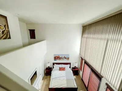 an attic room with a bed and a staircase at *WEHO/Beverly Hills* Luxury 2BD/2.5BA + Balconies in Los Angeles
