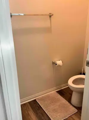 a bathroom with a toilet and a toilet paper roll at 3 Bedroom Townhome with Large Living Area in Downey