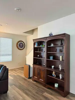 a large wooden book shelf in a living room at 3 Bedroom Townhome with Large Living Area in Downey