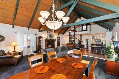 a living room with a wooden table and a couch at Large Comfy Family cabin-Great Kitchen, Pool Table, Pets welcome in Lake Arrowhead
