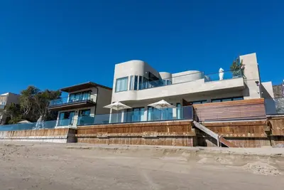 a house on the side of a beach at Malibu Sand Carbon Beach Suites in Malibu