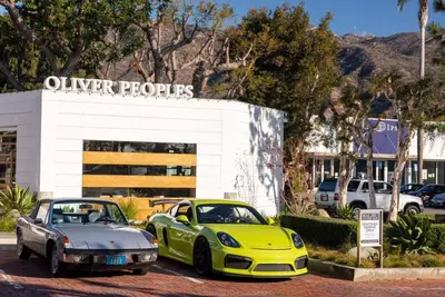 two cars parked in front of a car dealership at Malibu Sand Carbon Beach Suites in Malibu