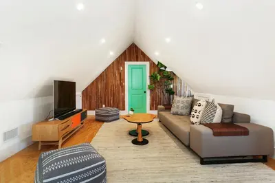 a living room with a couch and a tv at Peace Palace 56 in Los Angeles