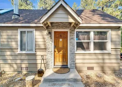a small house with a brown door and windows at Merri Bear in Big Bear Lake