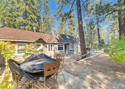 a house with a tarp on a table and two chairs at Merri Bear in Big Bear Lake